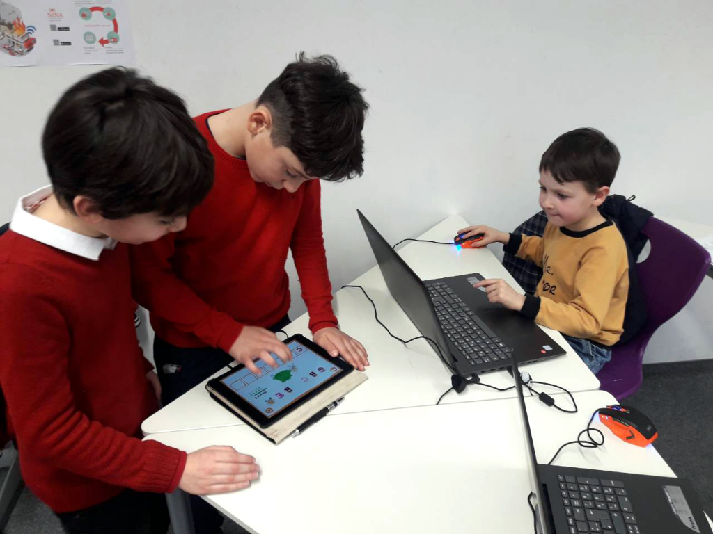 Children playing with an educational app on a tablet.